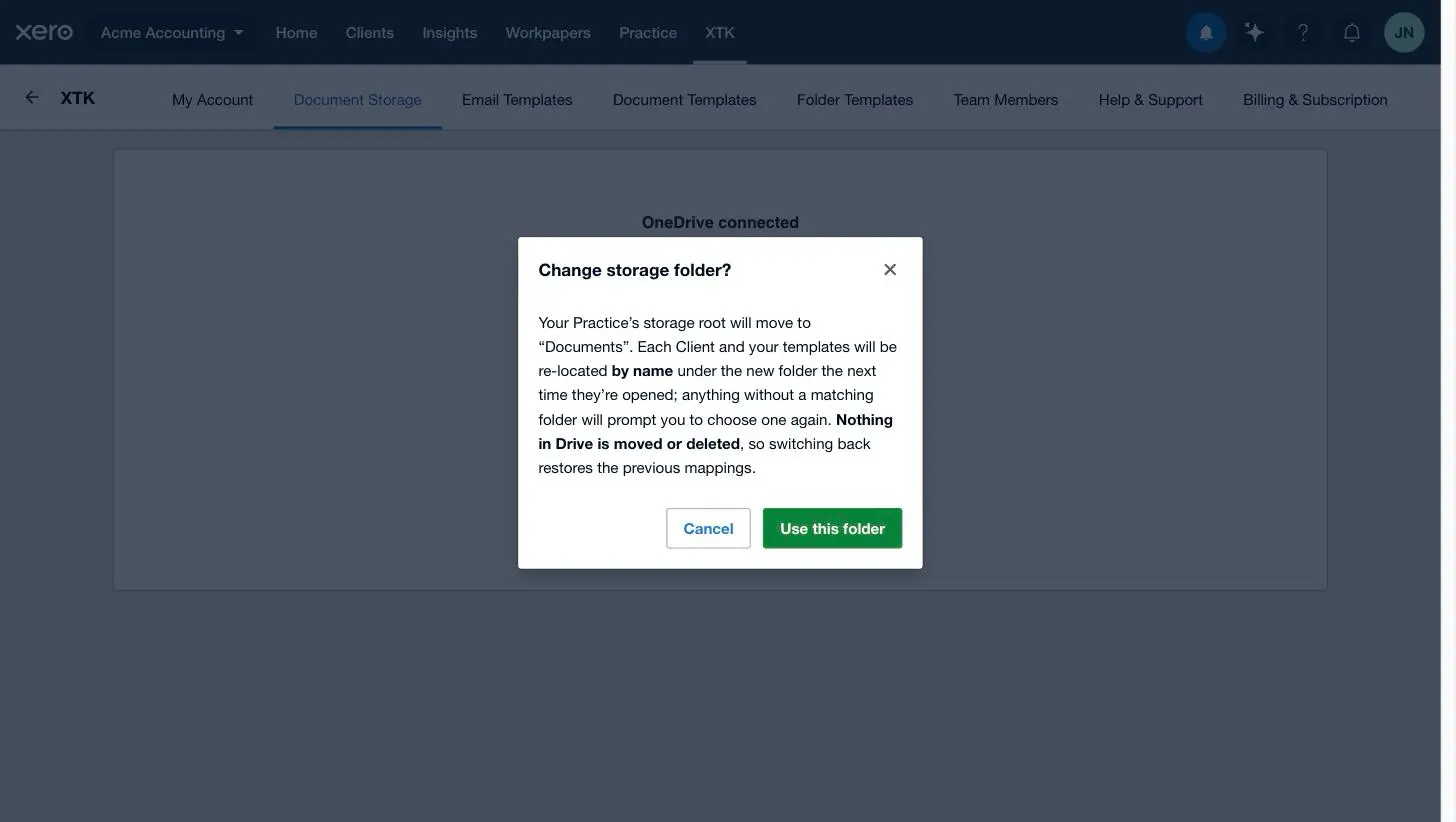 XTK's Change storage folder confirmation dialog explaining that clients re-locate by name and nothing in the drive is moved or deleted